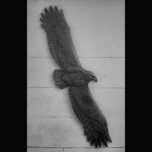 Eagle in flight Oak in relief